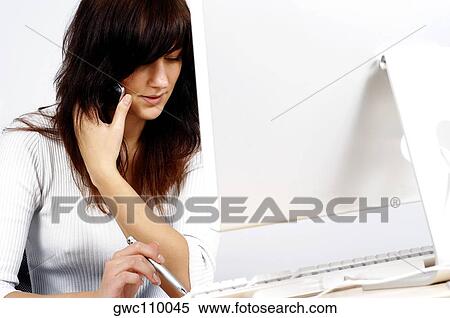 Close-up of a businesswoman talking on a mobile phone View Large Photo Image Stock Photography - Close-up of a businesswoman talking on a mobile phone. Fotosearch