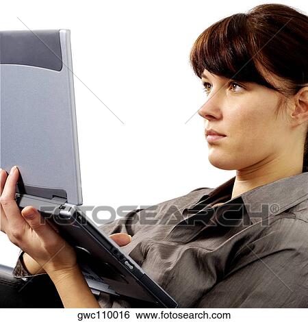 Close-up of a businesswoman working on a laptop View Large Photo Image Stock Photograph - Close-up of a businesswoman working on a laptop. Fotosearch