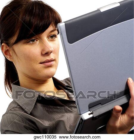 Close-up of a businesswoman working on a laptop View Large Photo Image Stock Photography - Close-up of a businesswoman working on a laptop. Fotosearch