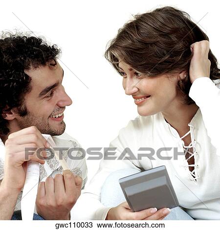 Close-up of a young couple smiling View Large Photo Image Stock Image - Close-up of a young couple smiling. Fotosearch