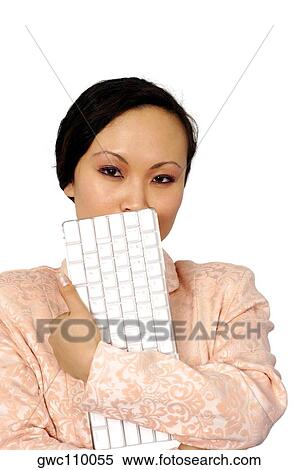 Portrait of a young woman holding a computer keyboard View Large Photo Image Stock Photography - Portrait of a young woman holding a computer keyboard. Fotosearch