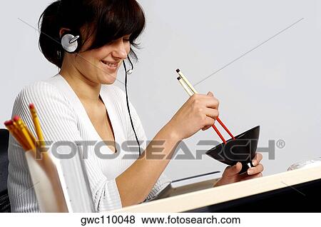 Side profile of a businesswoman holding chopsticks and a bowl View Large Photo Image Stock Photo - Side profile of a businesswoman holding chopsticks and a bowl. Fotosearch