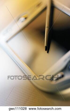 Stock Photo - Close-up of a digitized pen on a personal data assistant. Fotosearch