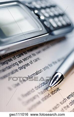 Stock Photograph - Close-up of a pen and a mobile phone on a document. Fotosearch