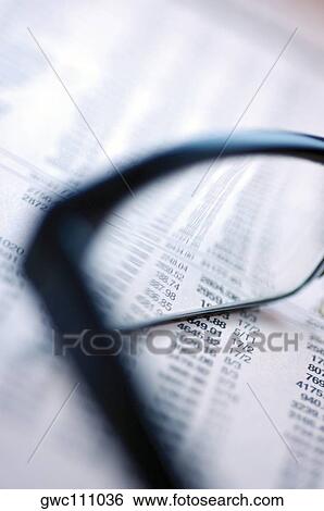 Stock Photograph - Pair of eyeglasses on a financial page. Fotosearch