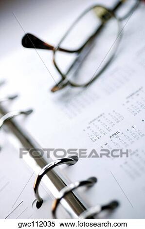 Close-up of eyeglasses on a personal organizer View Large Photo Image Stock Photography - Close-up of eyeglasses on a personal organizer. Fotosearch