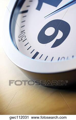 Stock Image - Close-up of number nine on a clock. Fotosearch