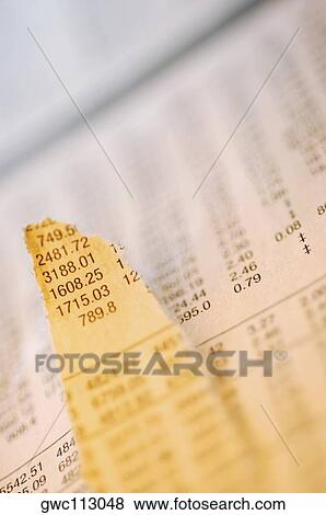 Close-up of a torn financial page View Large Photo Image Stock Photo - Close-up of a torn financial page. Fotosearch