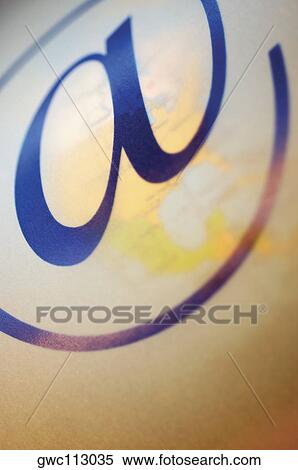 Close-up of 'an at' symbol over a globe View Large Photo Image Stock Photography - Close-up of 'an at' symbol over a globe. Fotosearch