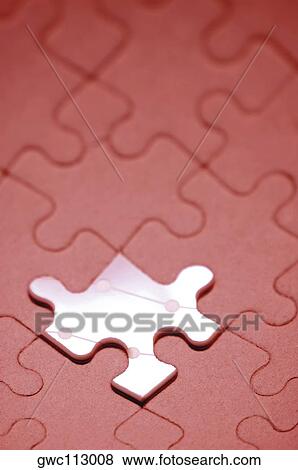 Stock Photo - Close-up of an odd piece in a jigsaw puzzle. Fotosearch