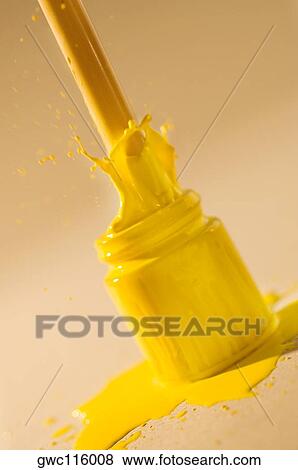 Close-up of a paintbrush dipped into a bottle of yellow paint View Large Photo Image Stock Photo - Close-up of a paintbrush dipped into a bottle of yellow paint. Fotosearch