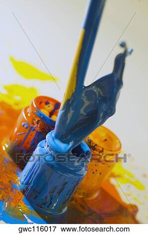 Close-up of a paintbrush dipped into a bottle of paint View Large Photo Image Stock Photo - Close-up of a paintbrush dipped into a bottle of paint. Fotosearch