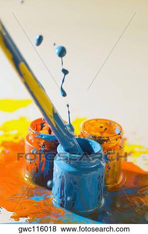 Close-up of a paintbrush dipped into a bottle of paint View Large Photo Image Stock Photo - Close-up of a paintbrush dipped into a bottle of paint. Fotosearch