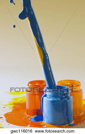 Stock Photograph - Close-up of a paintbrush dipped into a bottle of paint. Fotosearch