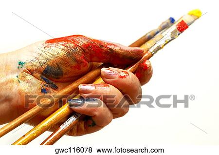Close-up of a person's hand holding paintbrushes View Large Photo Image Stock Photo - Close-up of a person's hand holding paintbrushes. Fotosearch