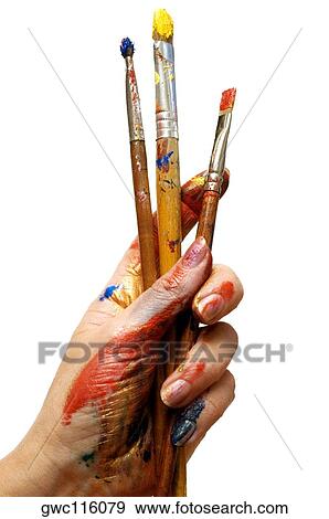 Close-up of a person's hand holding paintbrushes View Large Photo Image Stock Photo - Close-up of a person's hand holding paintbrushes. Fotosearch