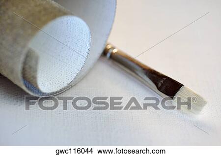 Close-up of a roll of canvas and a paintbrush View Large Photo Image Picture - Close-up of a roll of canvas and a paintbrush. Fotosearch