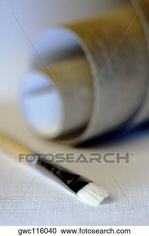 Close-up of a roll of canvas and a paintbrush View Large Photo Image Stock Image - Close-up of a roll of canvas and a paintbrush. Fotosearch