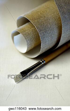 Close-up of a roll of canvas and a paintbrush View Large Photo Image Stock Image - Close-up of a roll of canvas and a paintbrush. Fotosearch