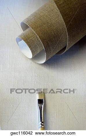 High angle view of a roll of canvas and a paintbrush View Large Photo Image Stock Image - High angle view of a roll of canvas and a paintbrush. Fotosearch