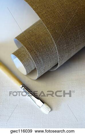 High angle view of a roll of canvas and a paintbrush View Large Photo Image Stock Photo - High angle view of a roll of canvas and a paintbrush. Fotosearch