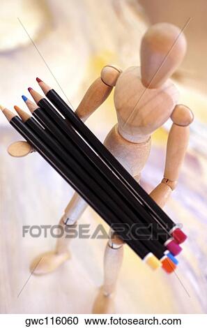 High angle view of color pencils on a wooden figurine View Large Photo Image Stock Image - High angle view of color pencils on a wooden figurine. Fotosearch