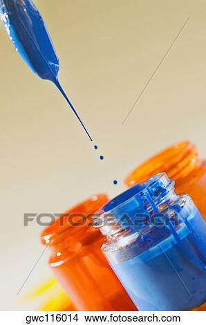 Paint dripping from a paintbrush into a bottle of paint View Large Photo Image Picture - Paint dripping from a paintbrush into a bottle of paint. Fotosearch