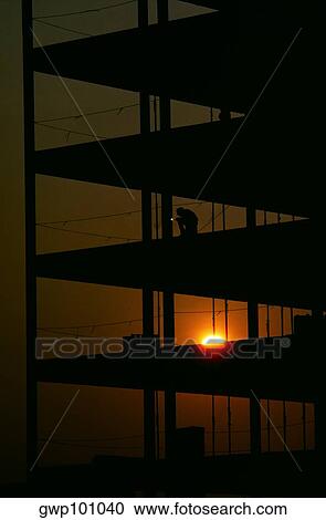 Welder on building at sunrise View Large Photo Image Stock Image - Welder on building at sunrise. Fotosearch