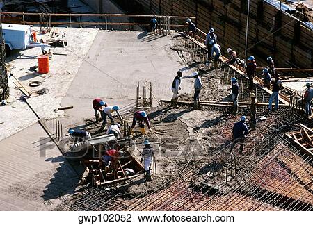 Construction workers on the construction site. View Large Photo Image Stock Image - Construction workers on the construction site.. Fotosearch