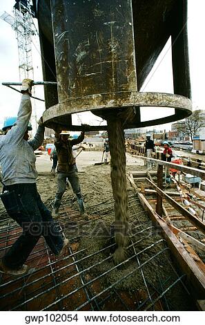 Picture - Construction workers pouring cement in new Office building in Bethesda, Maryland. Fotosearch