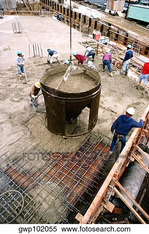 Stock Photography - Workers on construction site pouring cement in new office building in Bethesda, Maryland. Fotosearch