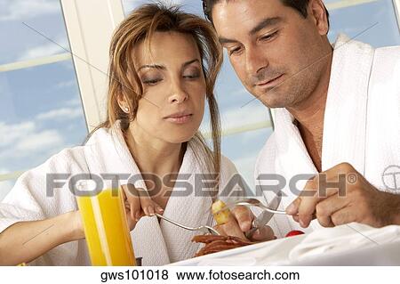 Close-up of a mid adult couple having breakfast View Large Photo Image Stock Photo - Close-up of a mid adult couple having breakfast. Fotosearch
