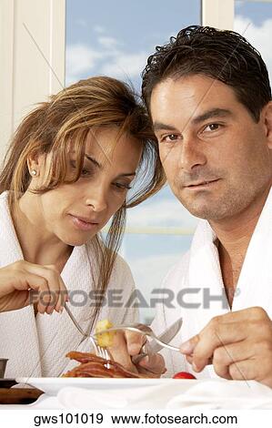 Stock Photo - Close-up of a mid adult couple having breakfast. Fotosearch