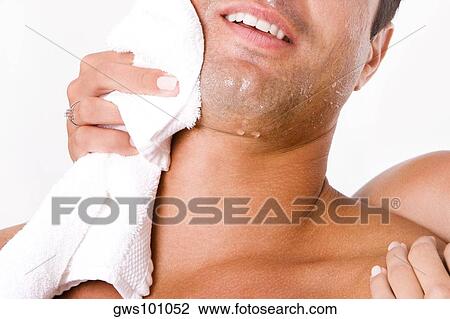 Close-up of a woman's hand wiping a mid adult man's face with a towel View Large Photo Image Stock Image - Close-up of a woman's hand wiping a mid adult man's face with a towel. Fotosearch