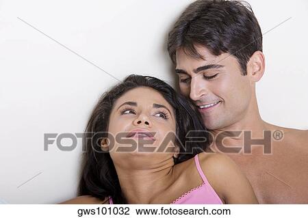 Close-up of a young couple smiling View Large Photo Image Stock Image - Close-up of a young couple smiling. Fotosearch