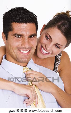 Close-up of a young woman adjusting a mid adult man's tie View Large Photo Image Stock Image - Close-up of a young woman adjusting a mid adult man's tie. Fotosearch