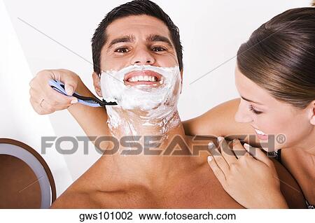 Close-up of a young woman shaving a mid adult man View Large Photo Image Stock Image - Close-up of a young woman shaving a mid adult man. Fotosearch