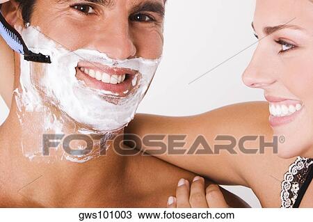Close-up of a young woman shaving a mid adult man View Large Photo Image Stock Image - Close-up of a young woman shaving a mid adult man. Fotosearch
