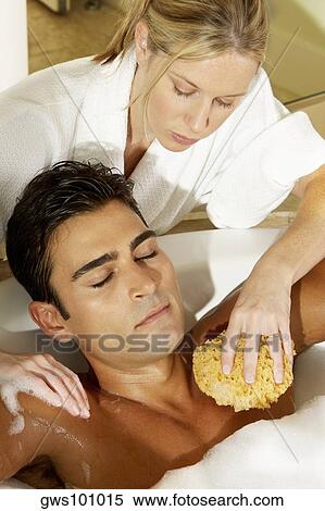High angle view of a young woman scrubbing a young man's chest with a bath sponge View Large Photo Image Stock Photography - High angle view of a young woman scrubbing a young man's chest with a bath sponge. Fotosearch