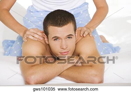 Portrait of a young man getting a shoulder massage View Large Photo Image Stock Photography - Portrait of a young man getting a shoulder massage. Fotosearch