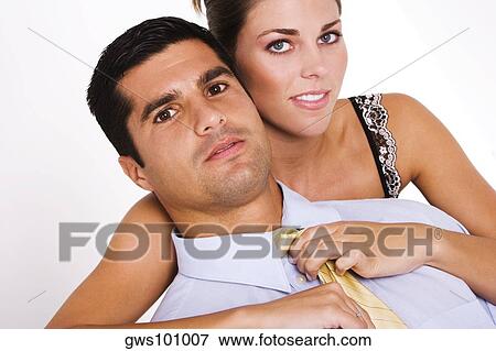Portrait of a young woman adjusting a mid adult man's tie View Large Photo Image Stock Photo - Portrait of a young woman adjusting a mid adult man's tie. Fotosearch