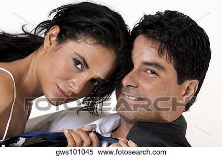 Portrait of a young woman adjusting a mid adult man's tie View Large Photo Image Stock Photography - Portrait of a young woman adjusting a mid adult man's tie. Fotosearch