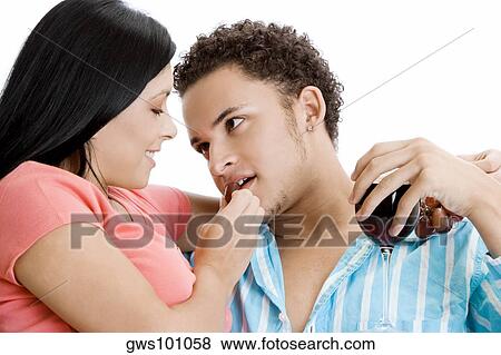 Portrait of a young woman feeding grapes to a young man View Large Photo Image Stock Photo - Portrait of a young woman feeding grapes to a young man. Fotosearch