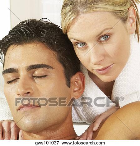 Stock Photo - Portrait of a young woman massaging a young man. Fotosearch