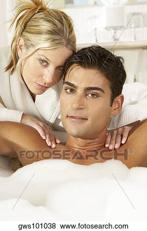 Portrait of a young woman massaging a young man in a bubble bath View Large Photo Image Stock Photo - Portrait of a young woman massaging a young man in a bubble bath. Fotosearch