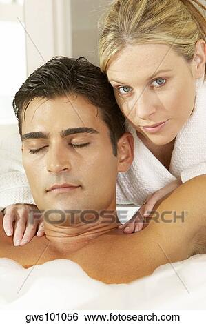 Portrait of a young woman massaging a young man in a bubble bath View Large Photo Image Stock Photograph - Portrait of a young woman massaging a young man in a bubble bath. Fotosearch