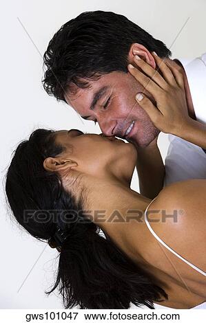 Rear view of a young woman kissing a mid adult man View Large Photo Image Stock Photo - Rear view of a young woman kissing a mid adult man. Fotosearch
