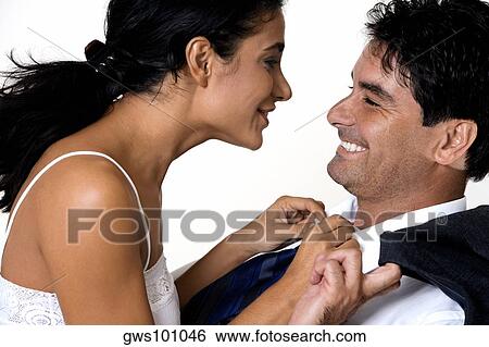 Side profile of a young woman and a mid adult man smiling View Large Photo Image Stock Photograph - Side profile of a young woman and a mid adult man smiling. Fotosearch