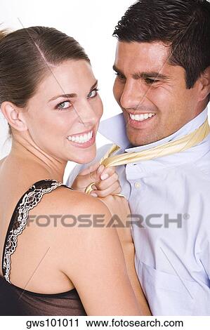 Side profile of a young woman pulling a mid adult man's tie View Large Photo Image Stock Image - Side profile of a young woman pulling a mid adult man's tie. Fotosearch