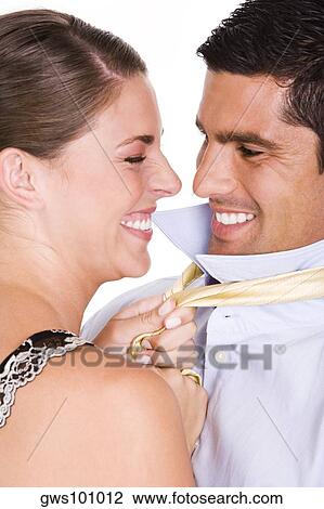 Side profile of a young woman pulling a mid adult man's tie View Large Photo Image Stock Image - Side profile of a young woman pulling a mid adult man's tie. Fotosearch